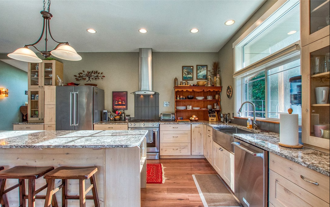 The remodeled kitchen with coordinated cabinetry, appliances and granite