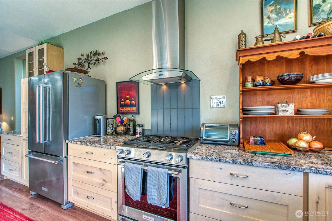 My finished kitchen showing the reclaimed space and the professional-style range at the heart of the room